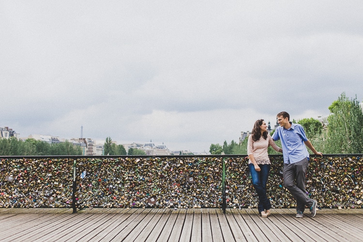 couple in love with Love locks on Pont des Arts Paris by jesuscaballero.com
