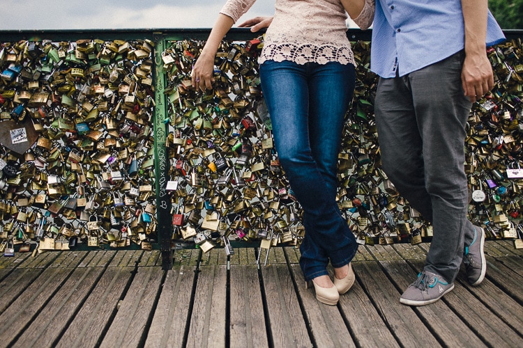 couple in love with Love locks on Pont des Arts Paris by jesuscaballero.com