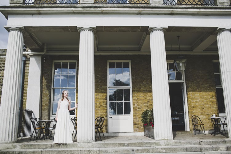 bride in columns at clissold house during wedding