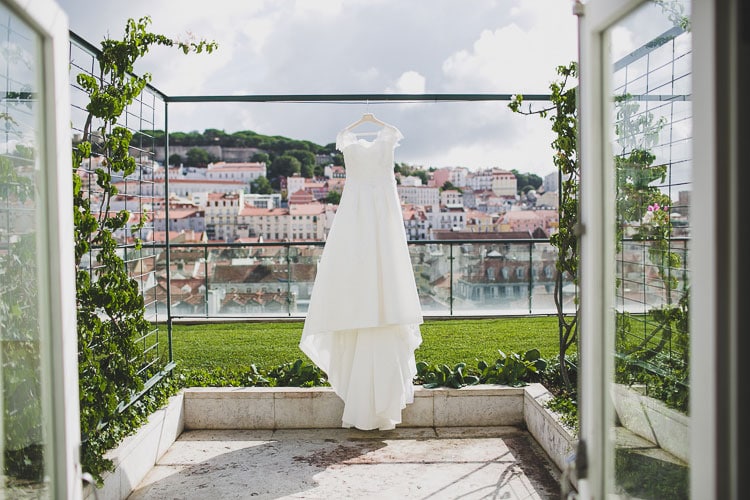 gown bride dress before the wedding in hotel chiado at lisbon with castle sao jorge view destination wedding portugal by jesus caballero