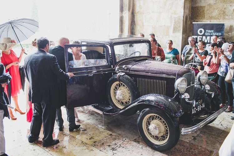 old car vintage ford for bride is coming in rainy day at wedding at monastery of jeronimos lisbon portugal