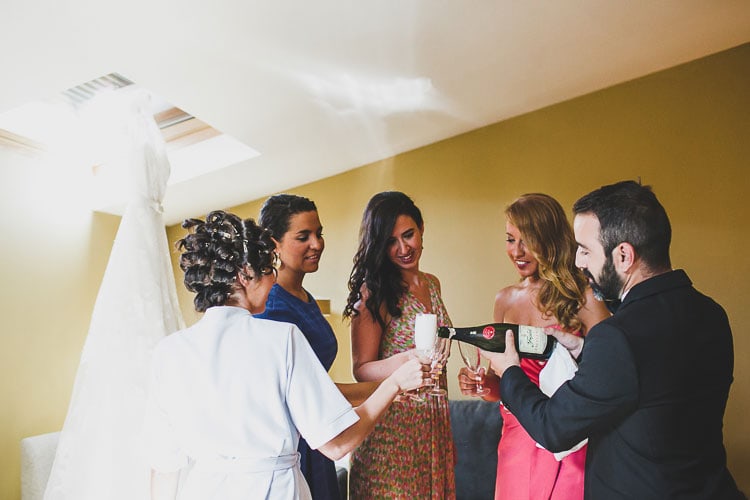 friends with champagne during the bride getting ready at a destination wedding. Charming Vintage Spanish Wedding caceres, jesus caballero photographer rustic wedding at a castle #castle #destination #spain #vintage #junebug #irish #londoners #ireland #uk #rosaclara #gown #whitedress