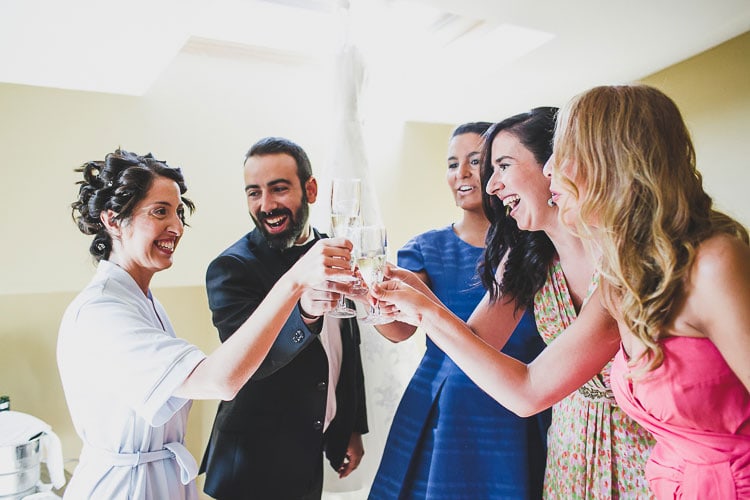 friends with champagne during the bride getting ready at a destination wedding. Charming Vintage Spanish Wedding caceres, jesus caballero photographer rustic wedding at a castle #castle #destination #spain #vintage #junebug #irish #londoners #ireland #uk #rosaclara #gown #whitedress