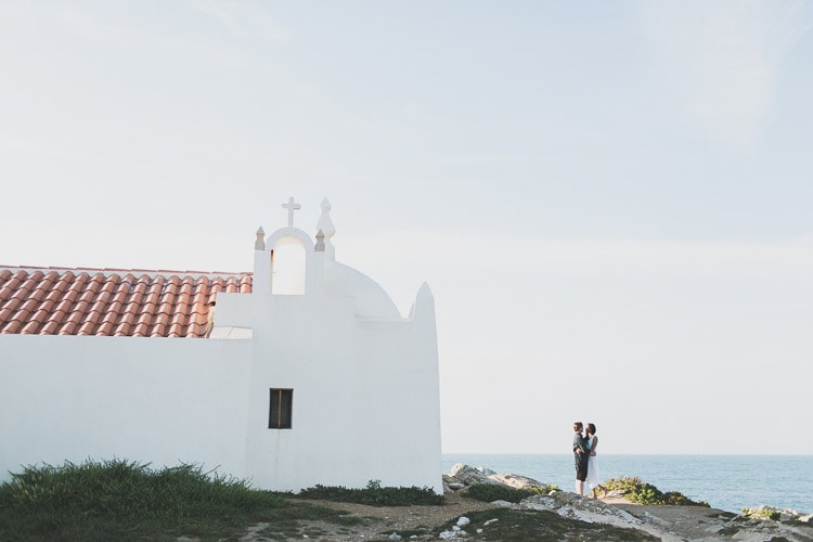intimate exchange of vows at the beach in a small elopement in Portugal, by obidos wedding photographer jesus caballero destination spot surf Peniche, little california