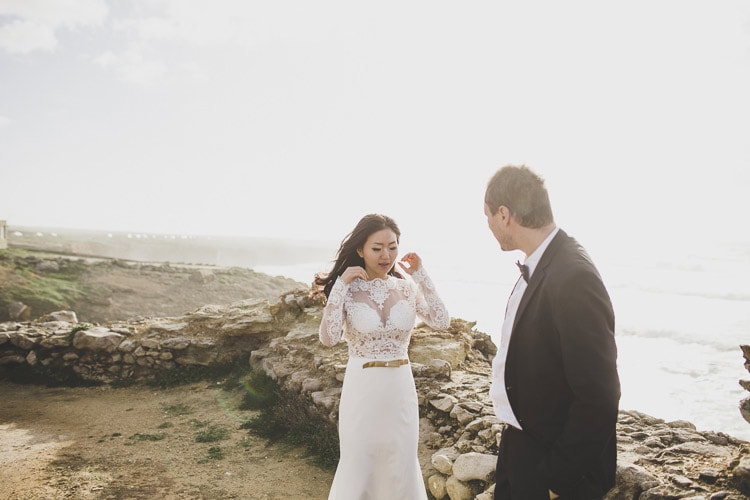 bride and groom at portugal cliffs