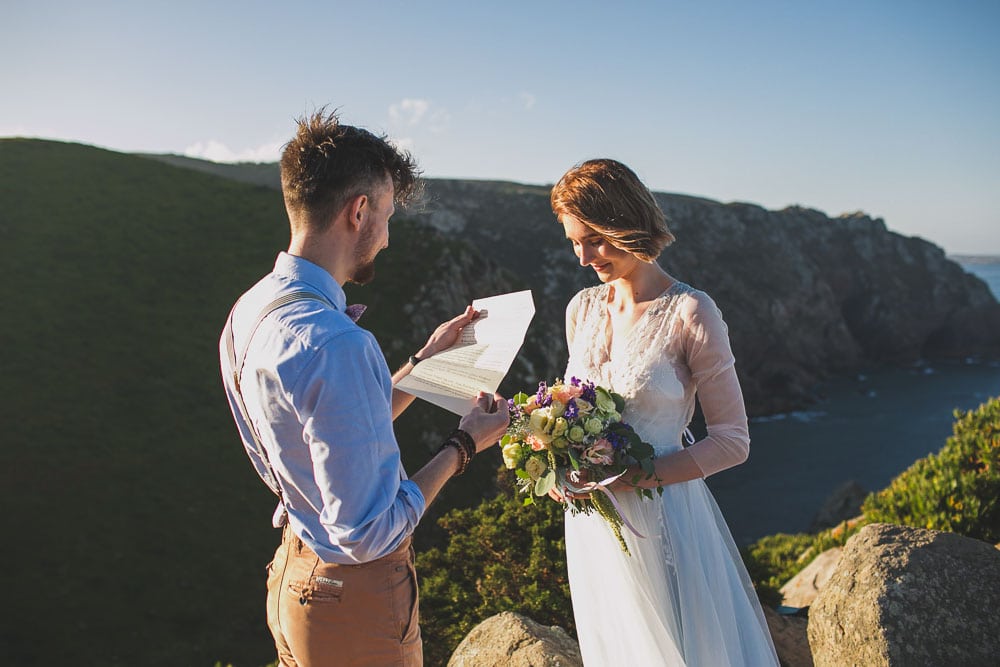 groom elopement with bride in elopement at mountain cliffs 