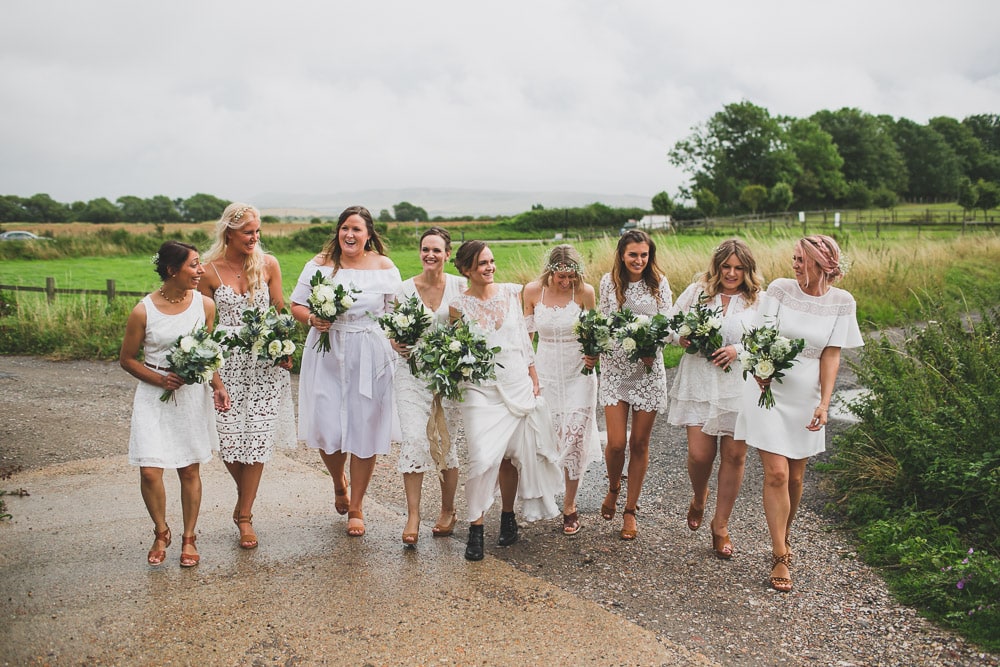 bride with Rime Arodaky And Black Biker Boots and bridesmaids at countryside boho wedding during getting ready lewes sussex UK