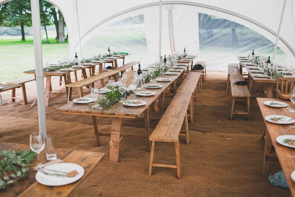East Sussex Rainy Festival Wedding photographer vintage furniture vintage trestle tables Eucalyptus greenery