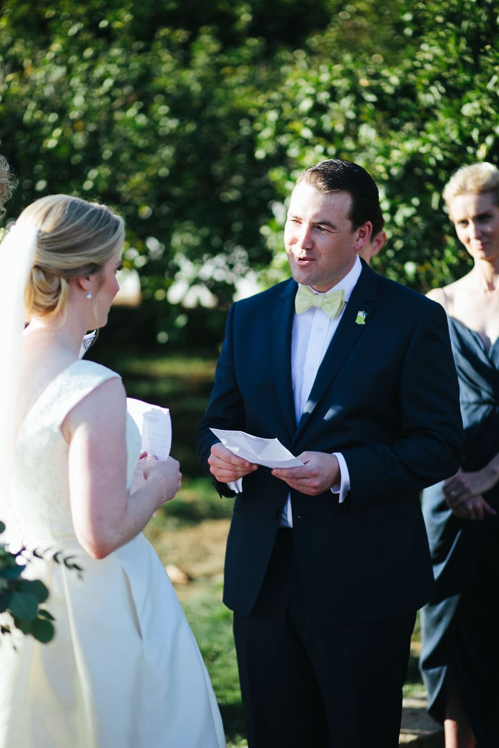 groom during vows at outdoor ceremony