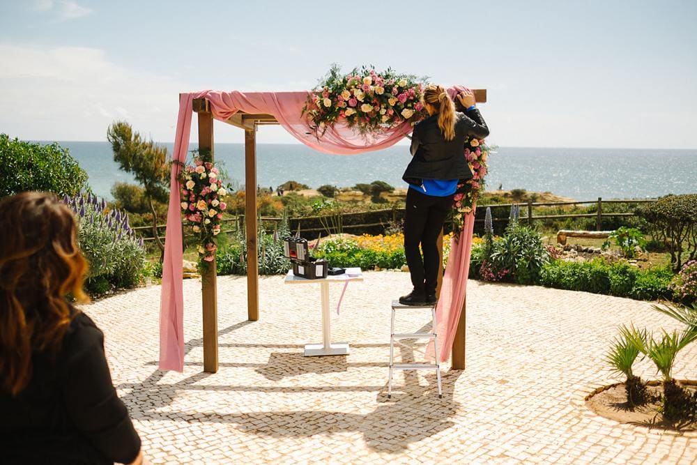floral arch beach wedding in suites alba resort by Ely Flores in Algarve with garden roses pink white and yellow www.jesuscaballero.com