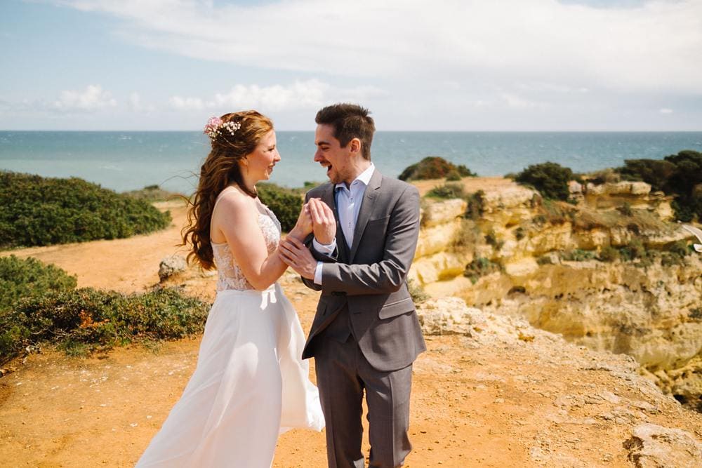 groom sees first time bride at first look at the cliffs in algarve