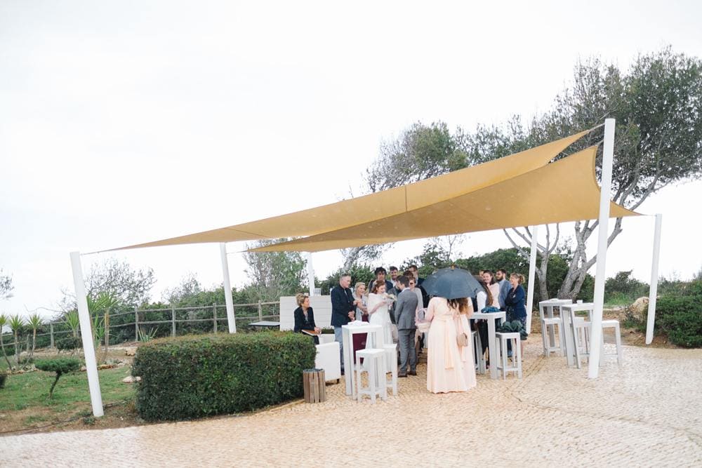 Algarve rainy wedding exchange rings with umbrella suites alba resort www.jesuscaballero.com