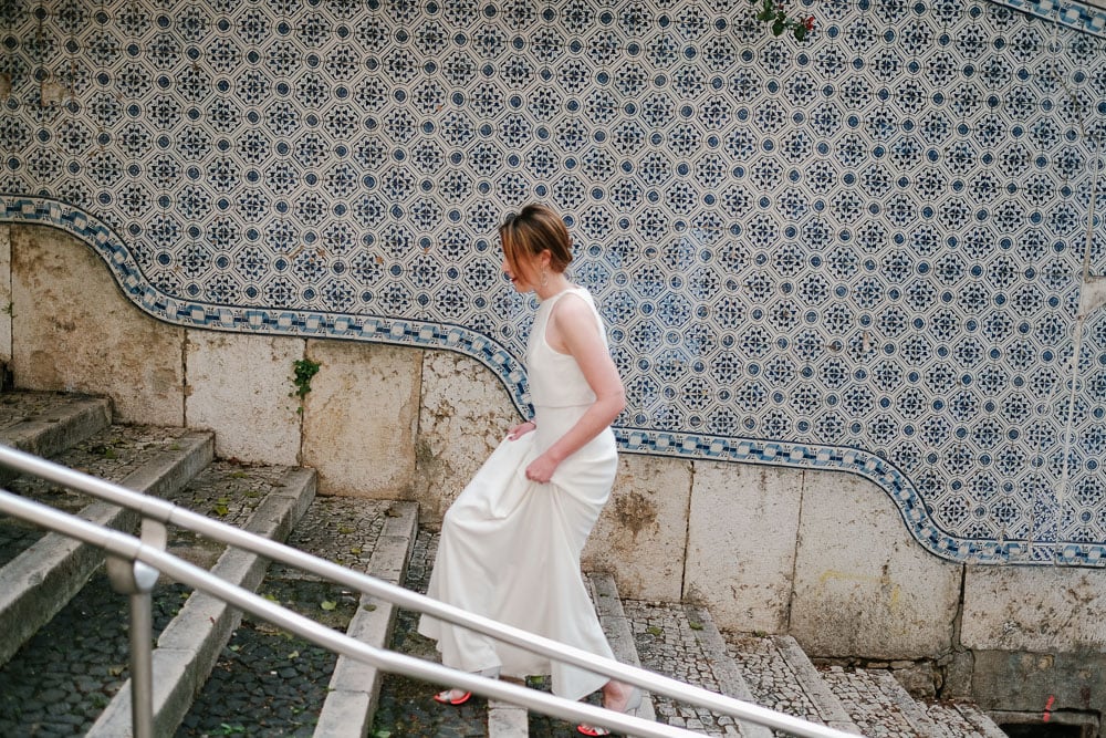 bride going to firstlook in elopement in Lisbon #lisbonelopement #urbanelopement #lisbonphotographer #portugalwedding #tiles #lisbontiles