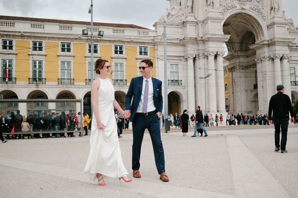 cool couple just married walking at commerce square in Lisbon