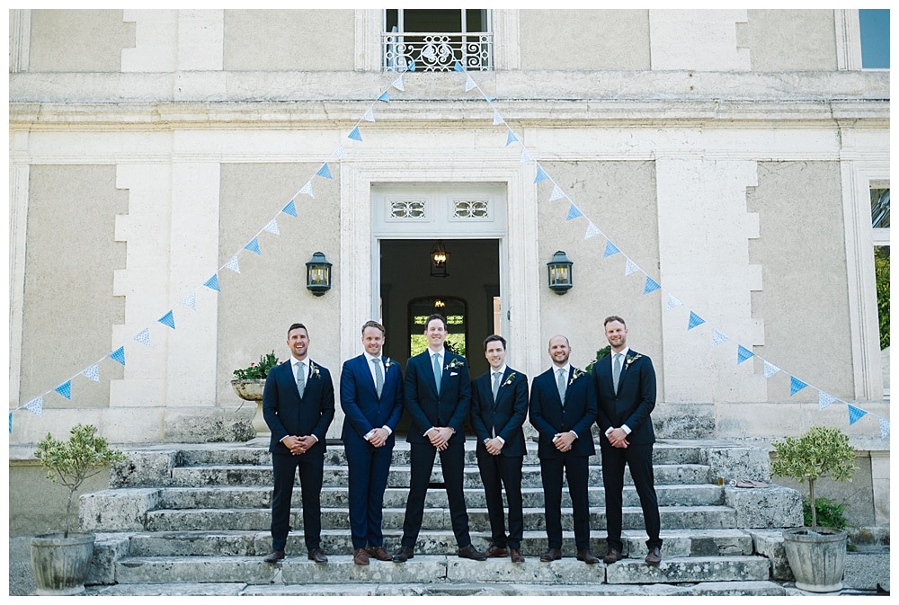 boys groomsmen and groom at front stairs chateau la gauterie