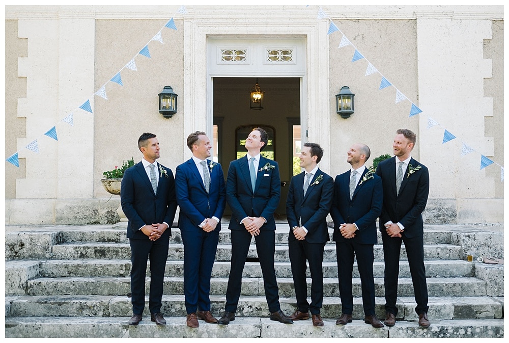 boys groomsmen and groom at front stairs chateau la gauterie