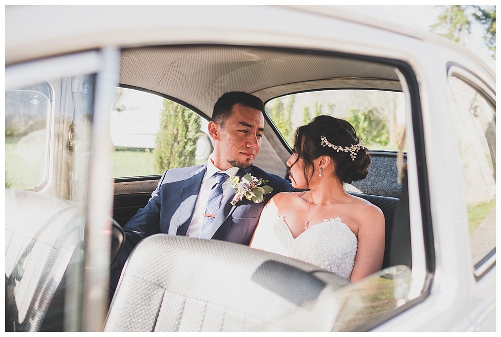 groom looking to bride after firstlook on a old fashioned vintage car