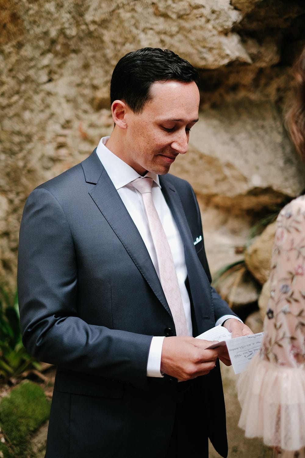 groom with vows during elopement