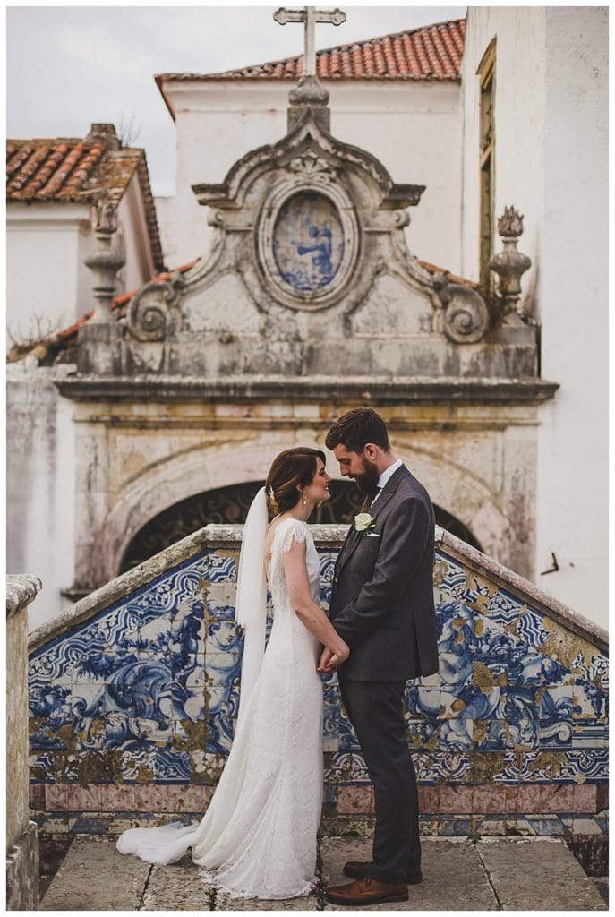 couple in front of portuguese tiles in lisbon wedding
