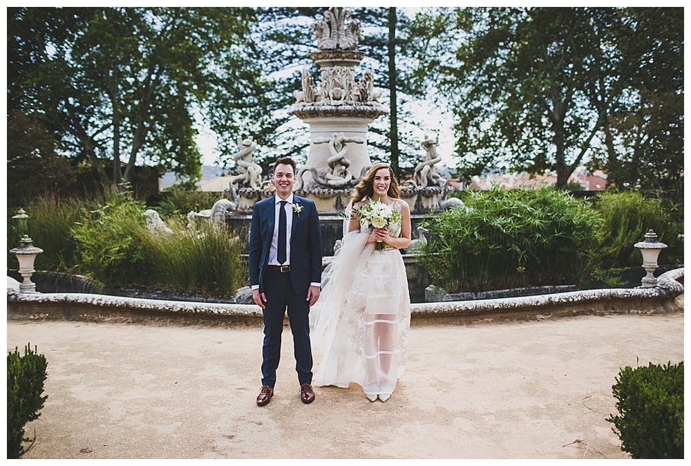 fun and smiling couple looking the camera in palace garden after elopement ceremony in Porto