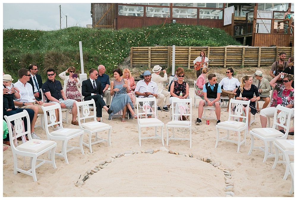 guest seated at the chair in the sand on the beach