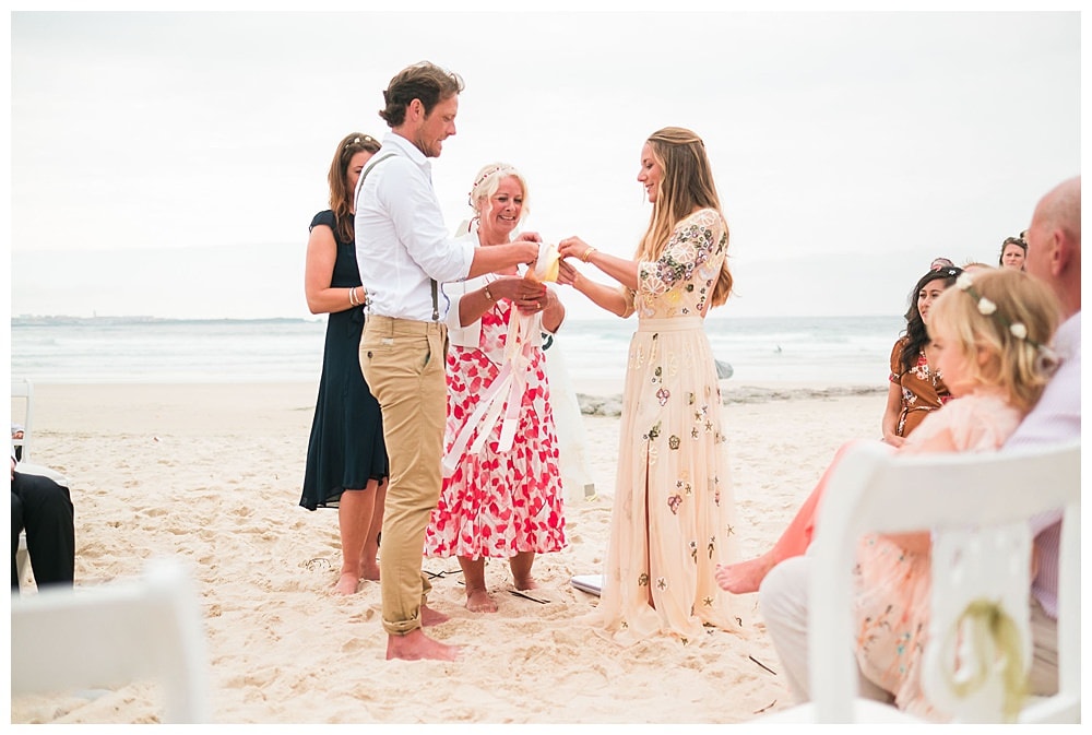 vows at beach wedding bride with boho dress needle and thread london #needleandthreadlondon #bohobride #surfwedding #surfbride #surfgroom #beachwedding #baleal