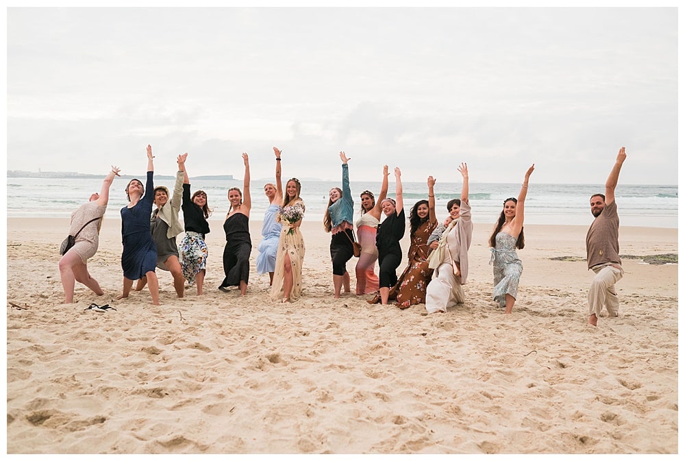 group of girls with bride yoga family at the sand beach #namaste #yogawedding #yogalife #beach #peniche #baleal #surf #beachwedding