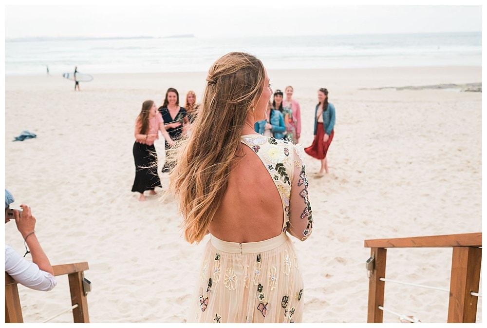 back of bride with boho dress needle and thread london #needleandthreadlondon #bohobride #surfwedding #surfbride #surfgroom #beachwedding #baleal