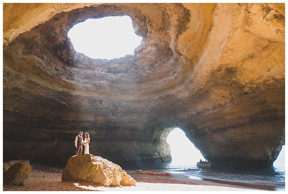couple in a impressive cave on the beach in Portugal for elopement