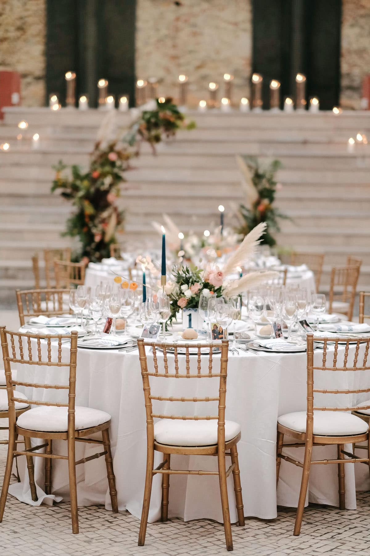 pampas centerpiece vessels and chairs with mixed dark green foliage and dried florals of peach and ivory blooms #pampascenterpiece #vesselsandchairs #darkgreenfoliage #driedflorals #peachandivory #blooms