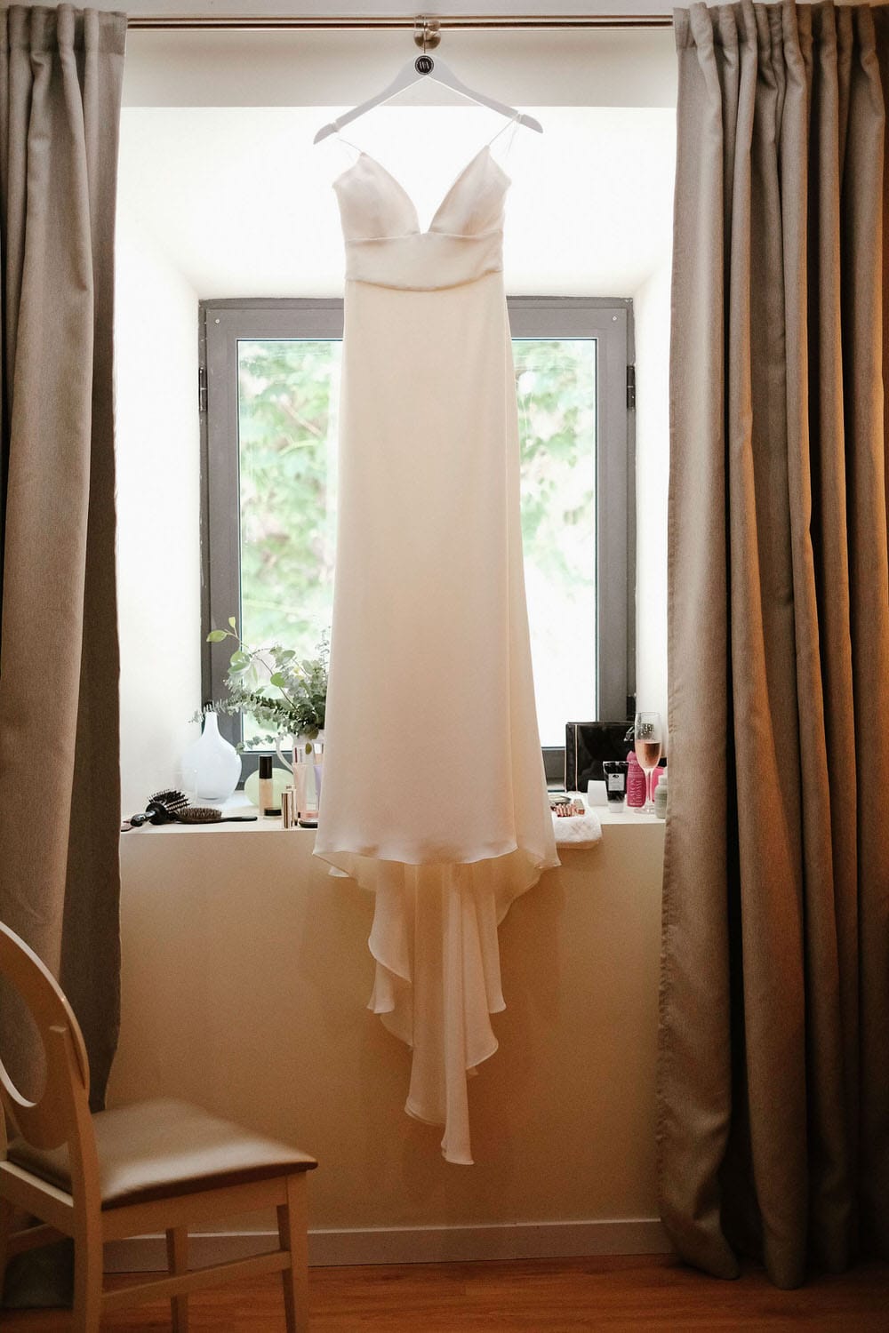 A London bride's dress, hanging in a warm room before the wedding at the quinta da bichinha