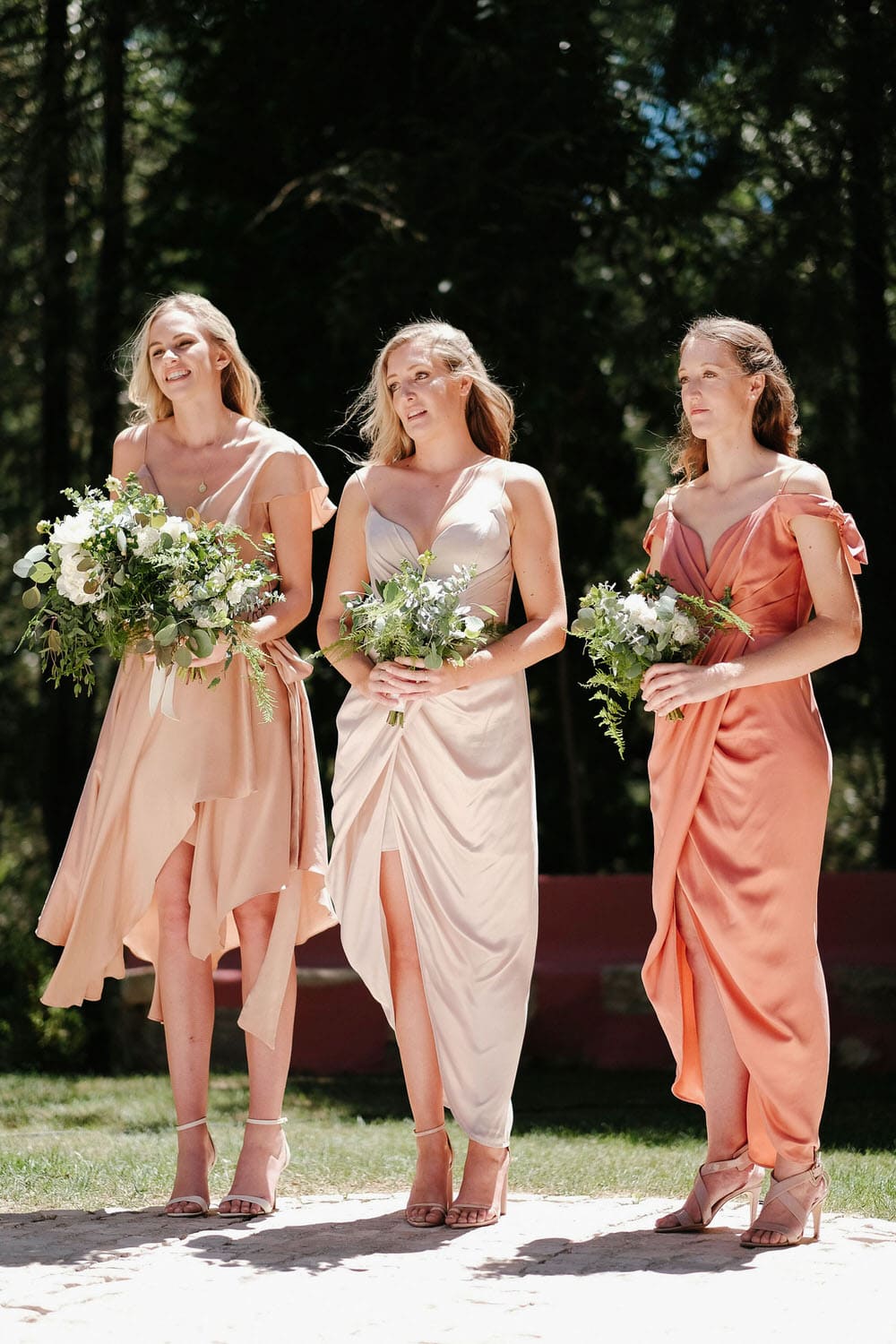 The smiling bridesmaids and maid of honor during the ceremony