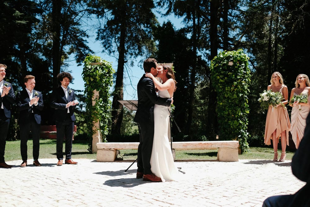The couple celebrates by raising their arms, after their first kiss before being introduced as newlyweds