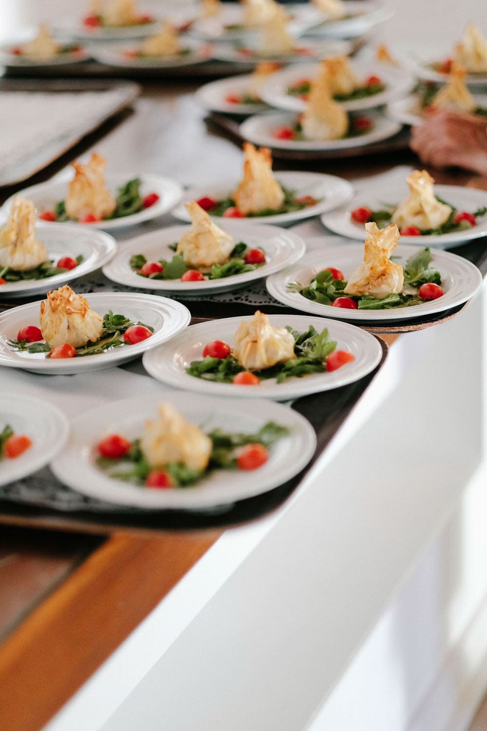 Sophisticated plates of food, symmetrically placed before being served at the wedding at the quinta da bichinha