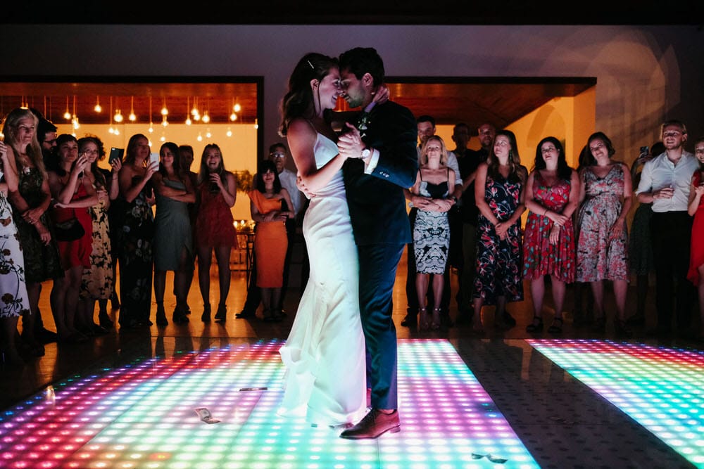 Quinta da Bichinha rustic destination wedding . The newlywed couple showcasing their style with beauty during the first dance on the LED dance floor at Quinta da Bichinha