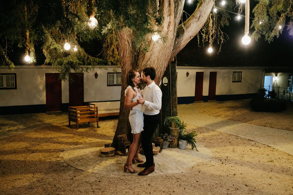 Quinta da Bichinha rustic destination wedding . The newlyweds share a romantic dance under the tree and lantern lights, creating a warm and intimate scene