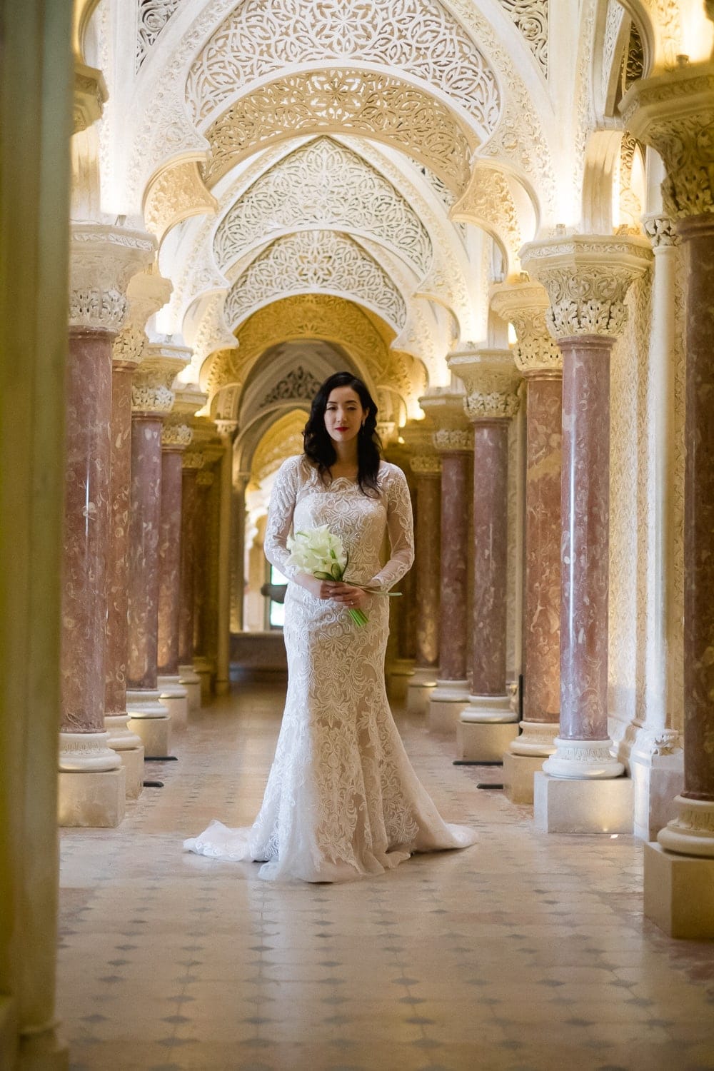 bride walking down the columns corridor at the Monserrate Palace in Sintra