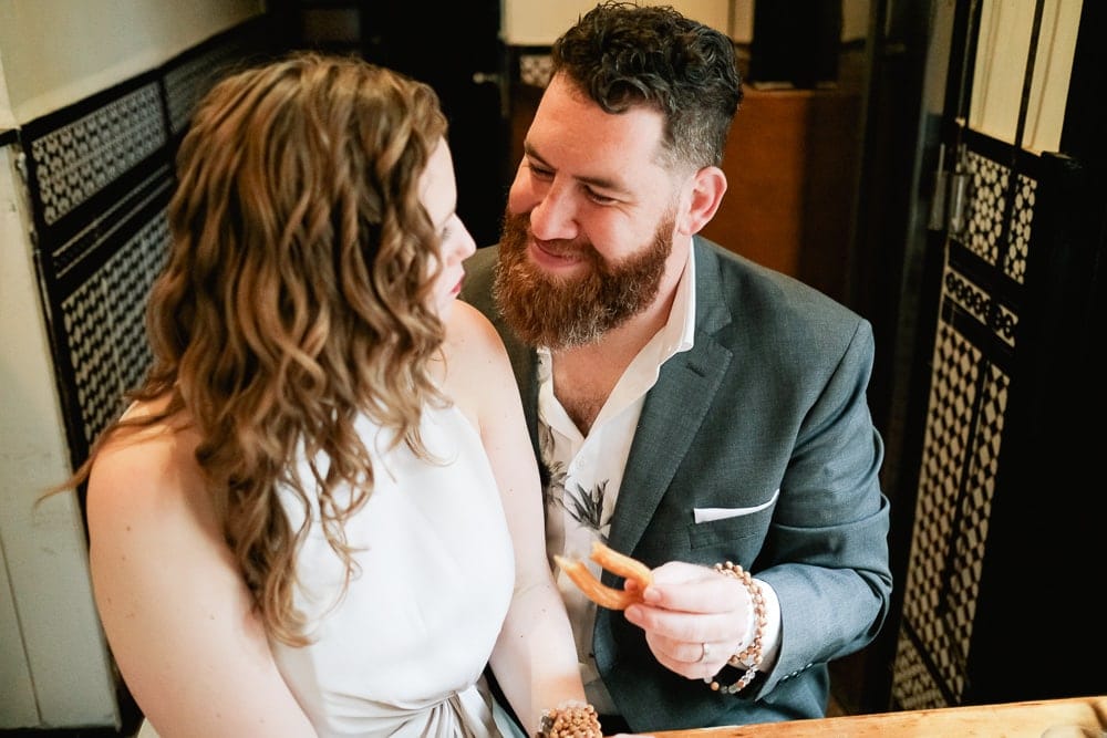 eating churros in jewish quarter in seville elopement photographer