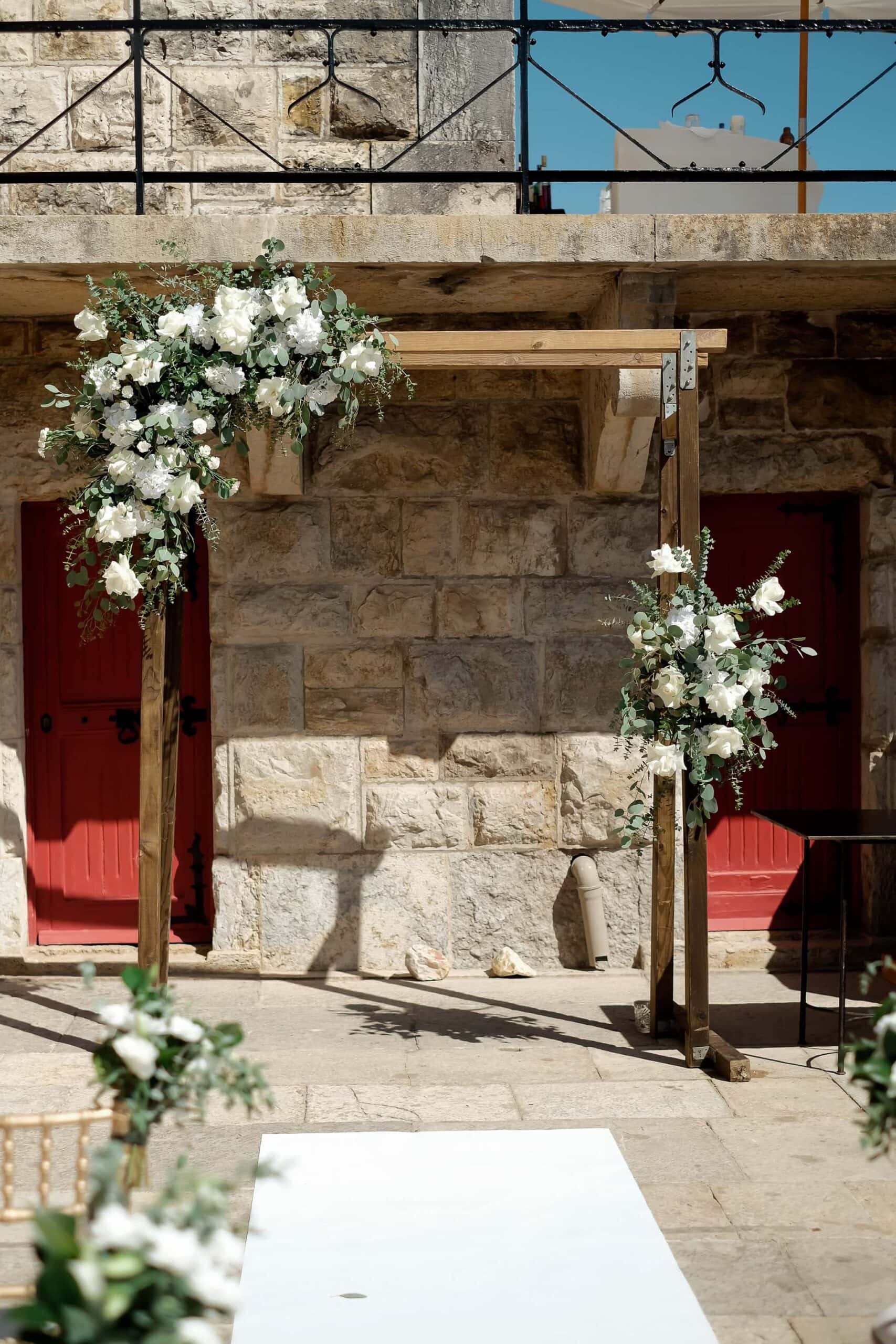 White flowers arc at Forte da Cruz Wedding