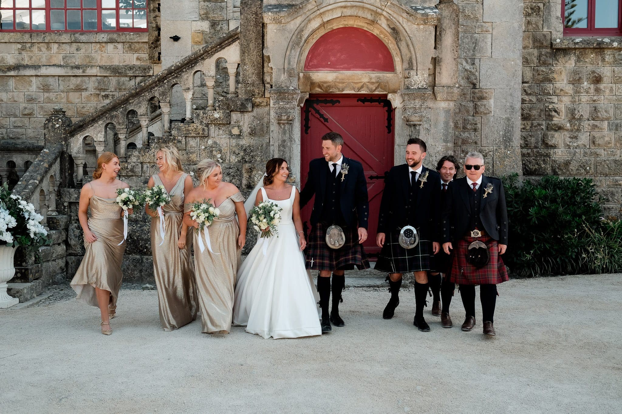 wedding party with bridesmaids with champagne dress color and Scottish boys with kilt at Forte da Cruz Wedding